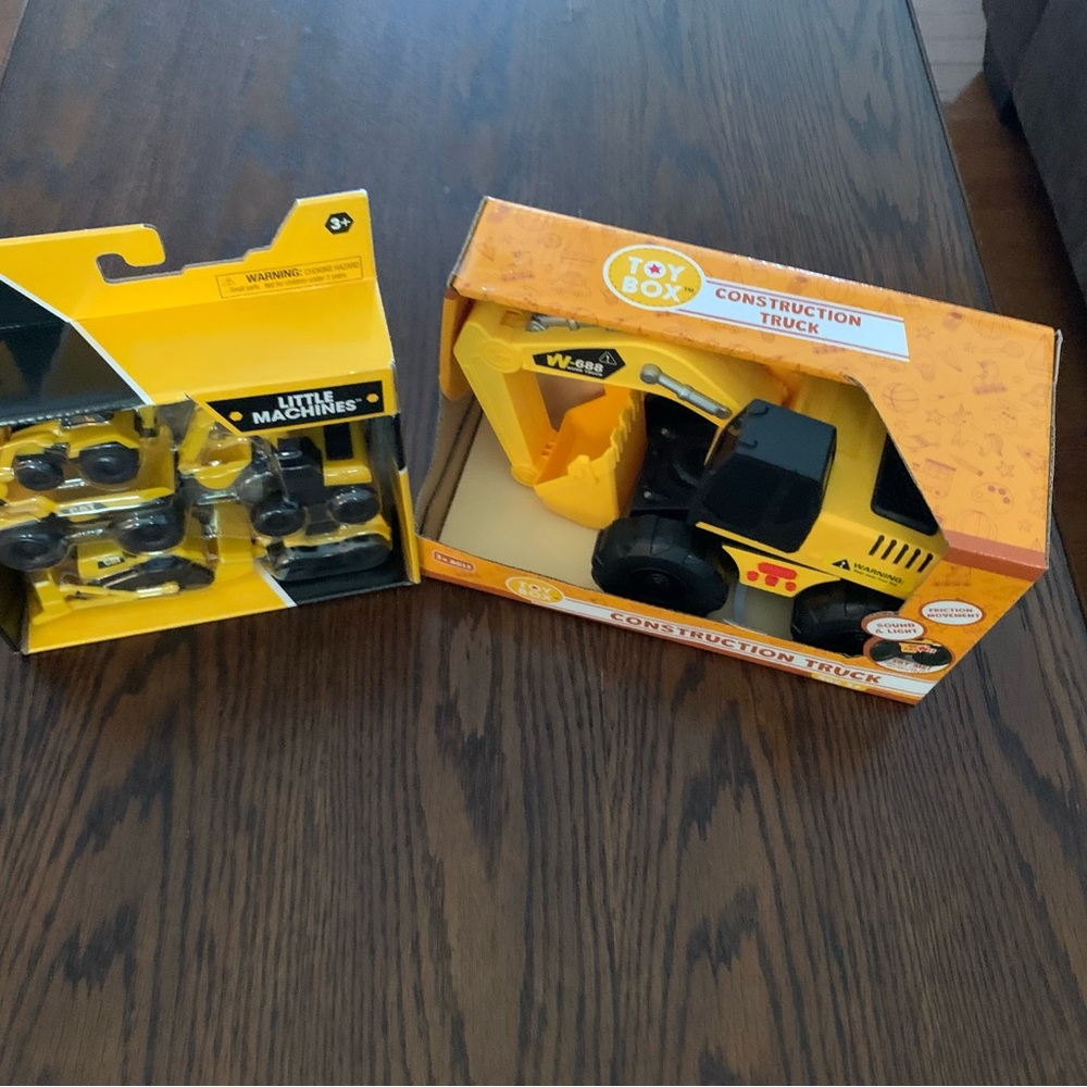 Yellow construction vehicles digger 4 by 10 in. and small construction vehicles